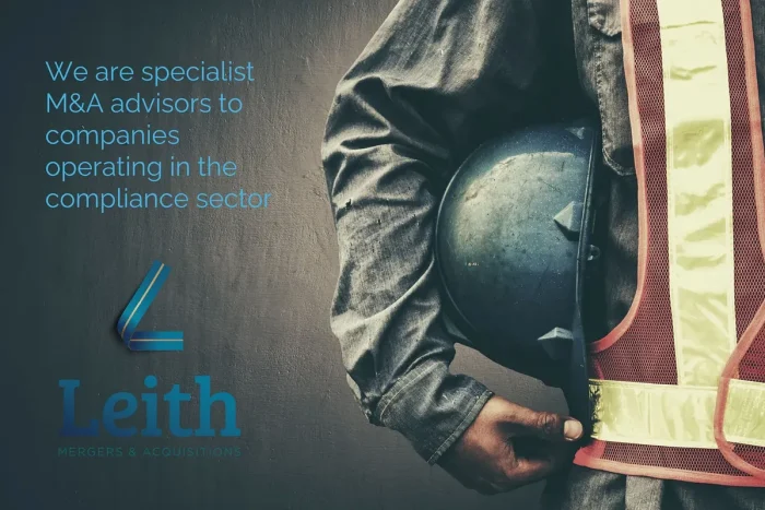 A worker holding a hard hat, beside the words: we are specialist M&A advisors to companies operating in the compliance sector